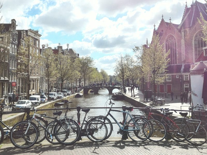 des vélos stationnés contre la rambarde d'un pont à Amsterdam
